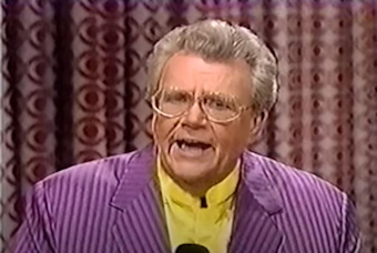 Rod is wearing a purple/purple striped jacket & yellow silk collarless shirt