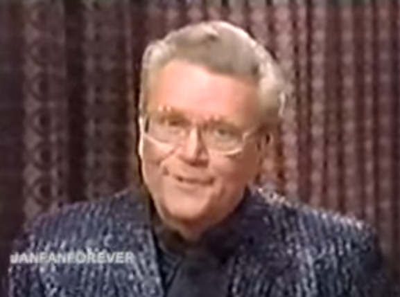 Rod is wearing a black sequined jacket & black silk collarless shirt