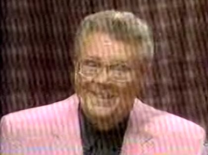 Rod is wearing a pink jacket & black shirt