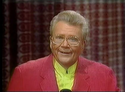 Rod is wearing a red jacket & yellow collarless silk shirt