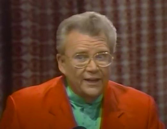 Rod is wearing a red jacket & green silk collarless shirt