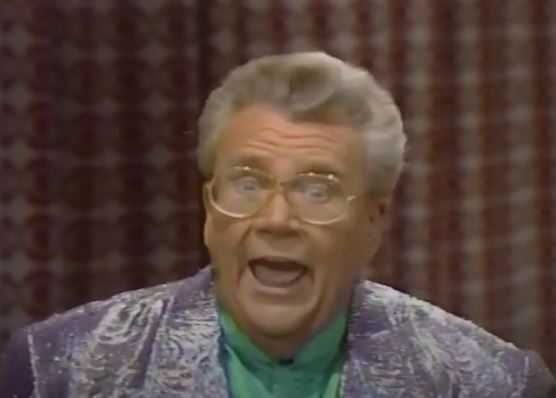Rod is wearing a silver jacket & lime-green silk collarless shirt