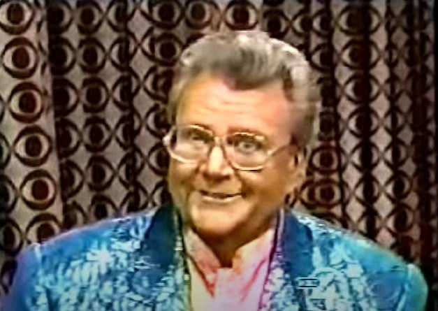 Rod is wearing a teal-blue sequined jacket & pink silk collarless shirt