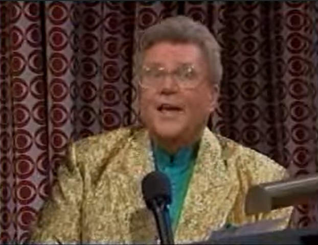 Rod is wearing a gold sequined jacket & teal collarless silk shirt
