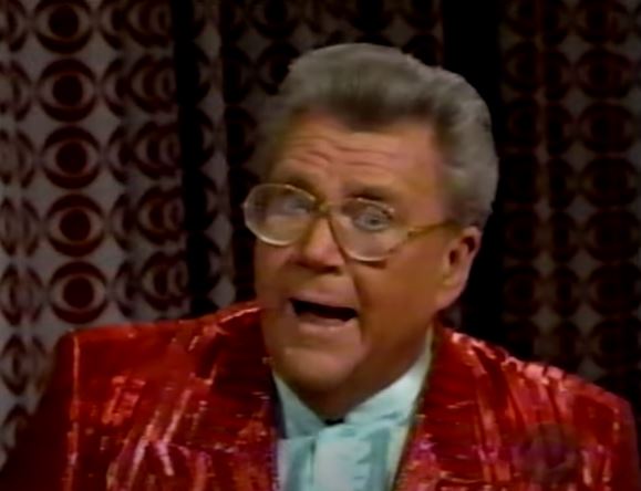 Rod is wearing a shiny red/red-stripe jacket & very pale-blue silk collarless shirt