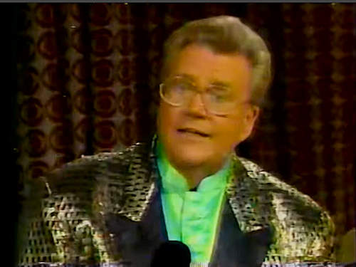 Rod is wearing a gold leopard-print jacket with black lapels & lime-green collarless silk shirt