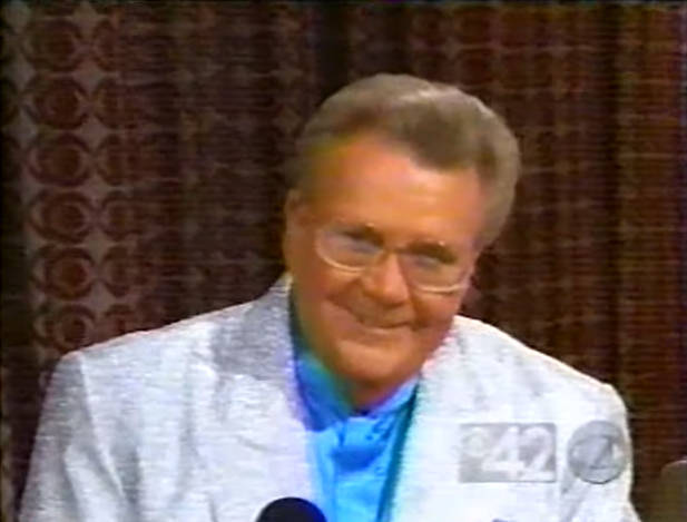 Rod is wearing a silver sequined jacket & robins-egg blue collarless silk shirt