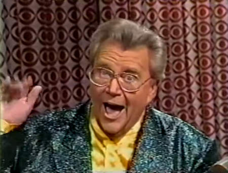 Rod is wearing a sparkly dark-green jacket & yellow collarless silk shirt