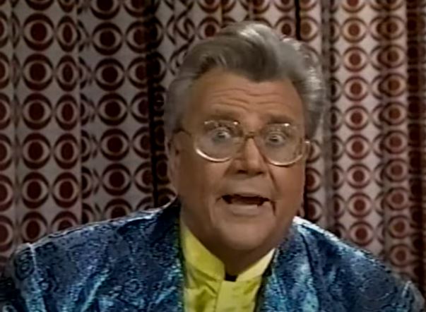 Rod is wearing a blue sequined jacket & yellow collarless silk shirt