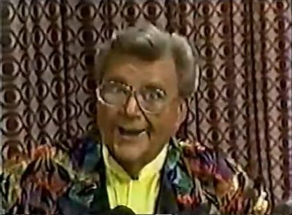 Rod is wearing a rainbow-leaf patterned jacket with black lapels & yellow collarless silk shirt