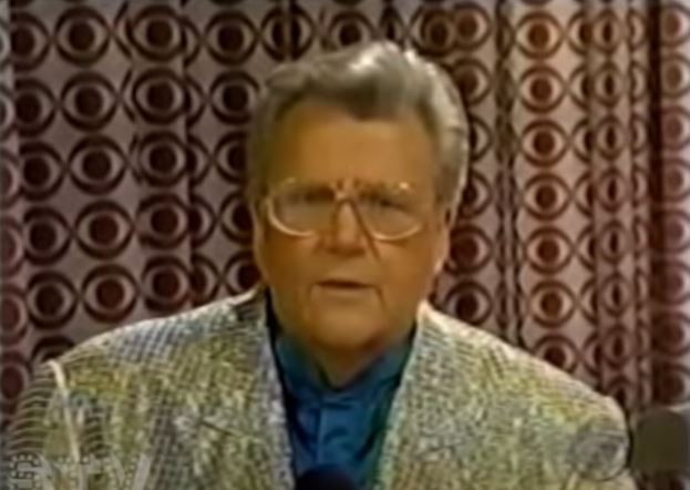 Rod is wearing a gold sequined jacket & dark-green silk collarless shirt