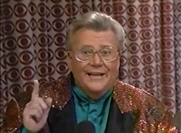 Rod is wearing a brown sequined jacket with black lapels & a seafoam-green collarless silk shirt