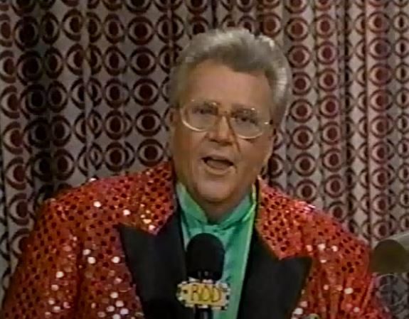 Rod is wearing a red sequined jacket with black lapels & green silk collarless shirt