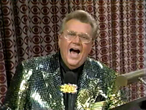 Rod is wearing a gold jacket with black sequins & black collarless silk shirt with matching pocketsquare