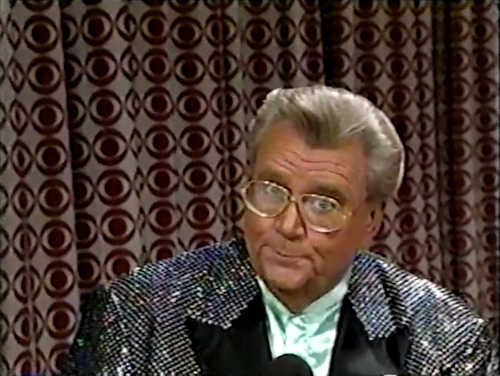 Rod is wearing a black sequined jacket & pale mint-green collarless silk shirt