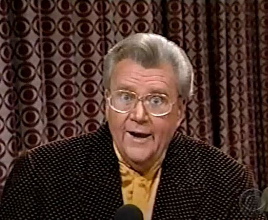 Rod is wearing a black jacket with yellow dots & mustard-yellow collarless silk shirt