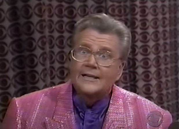 Rod is wearing a pinkk sequined jacket & purple collarless silk shirt