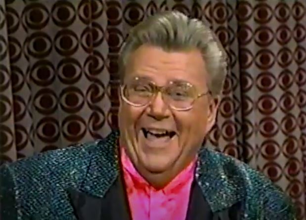 Rod is wearing a dark-green sequined jacket & pink silk collarless shirt