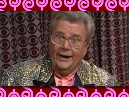 Rod is wearing a gold sequined jacket with black lapels & peach collarless silk shirt