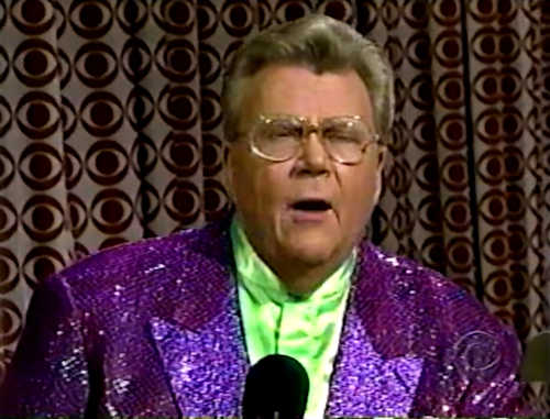 Rod is wearing a purple sequined jacket & lime-green collarless silk shirt