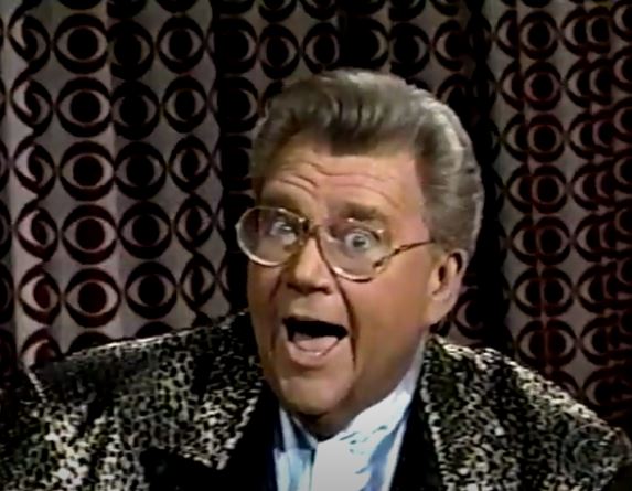 Rod is wearing a leopard-print jacket with black lapels and a powder-blue collarless silk shirt