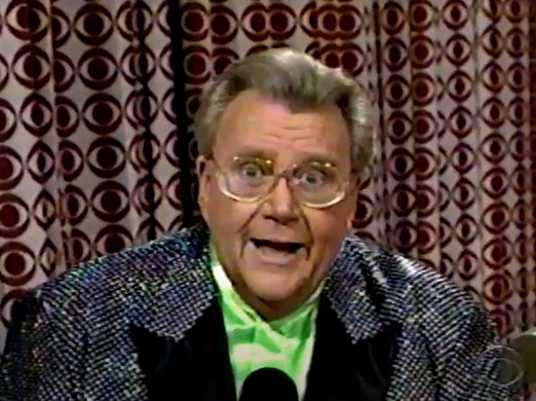 Rod is wearing a black sequined jacket with black lapels & lime-green collarless silk shirt