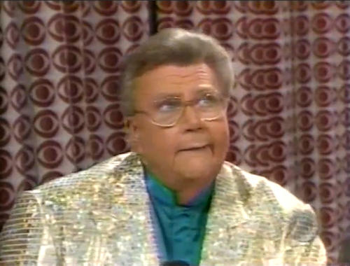 Rod is wearing a gold sequined jacket & dark-green collarless silk shirt