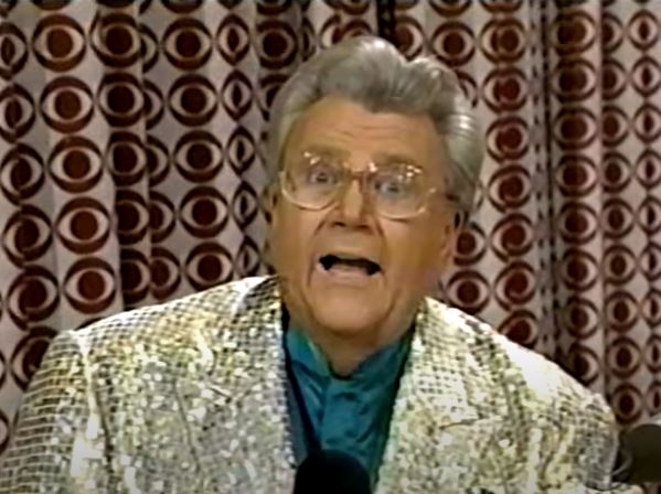 Rod is wearing a gold sequined jacket & dark-green collarless silk shirt