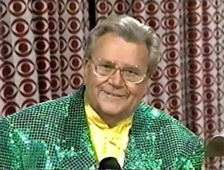 Rod is wearing a green sequined jacket & yellow collarless silk shirt
