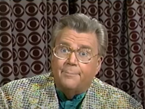 Rod is wearing a gold sequined jacket & green collarless silk shirt