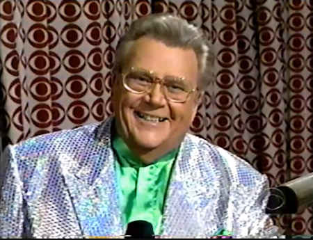 Rod is wearing a silver-sequin jacket & lime-green collarless silk shirt with matching pcket square