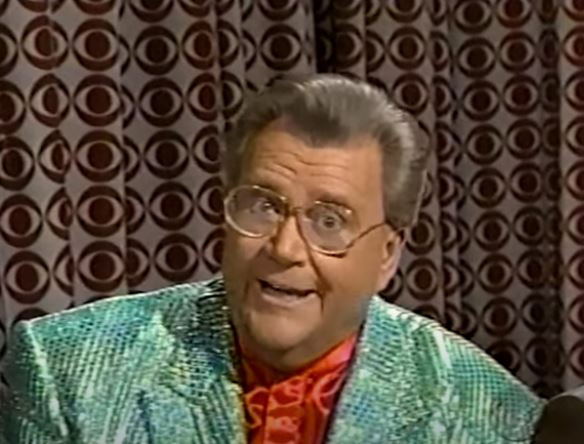 Rod is wearing a green pinstripe/sequin jacket & red silk shirt