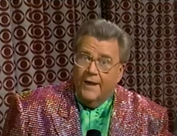 Rod is wearing a red sequined jacket & green collarless silk shirt