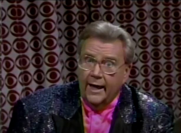 Rod is wearing a black sequined jacket & pink collarless silk shirt