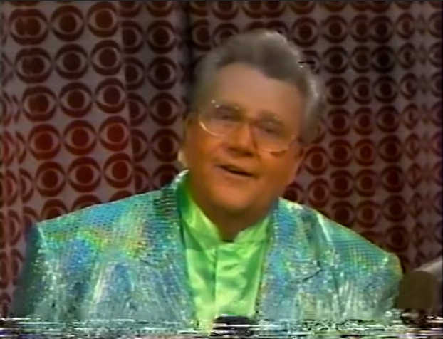 Rod is wearing a silver-green sequined jacket & lime-green collarless silk shirt