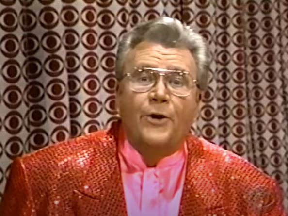 Rod is wearing a red sequined jacket & pink silk collarless shirt