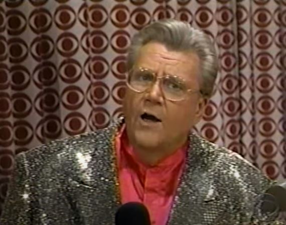 Rod is wearing a gold sequined jacket & salmon collarless silk shirt