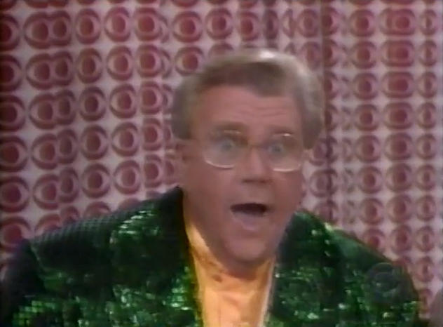 Rod is wearing a Dark-green sequined Jacket & Mustard-yellow collarless silk shirt