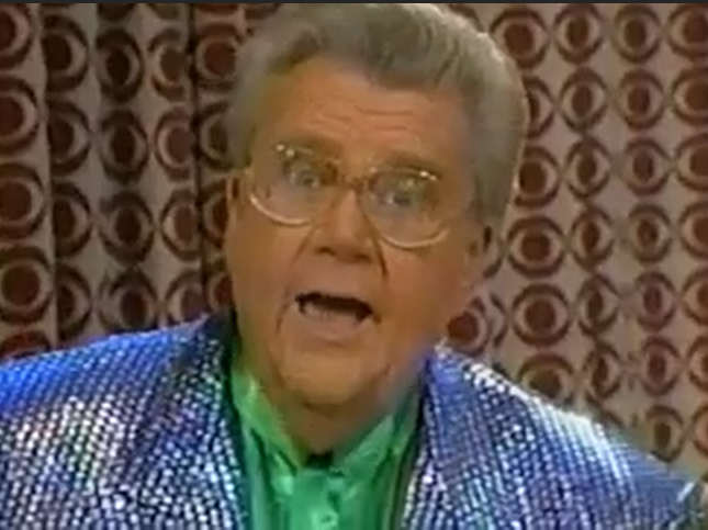 Rod is wearing a silver-blue sequined jacket & green collarless silk shirt