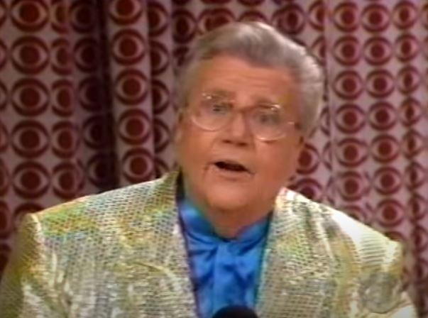 Rod is wearing a gold sequined jacket & light blue collarless silk shirt