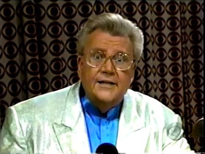 Rod is wearing a shiny mint-green jacket & light-blue collarless silk shirt