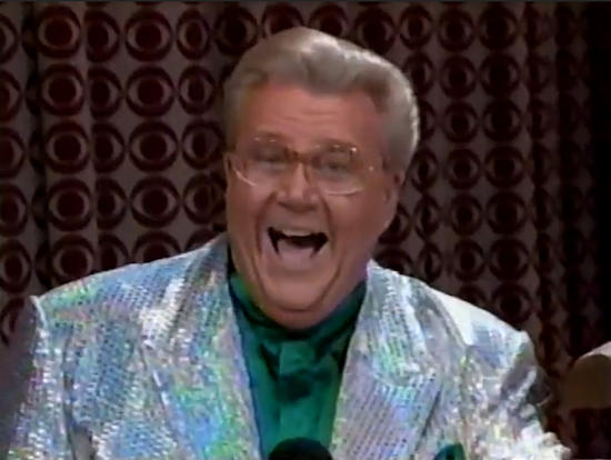 Rod is wearing a silver sequined jacket & dark-green collarless silk shirt with matching pocket square