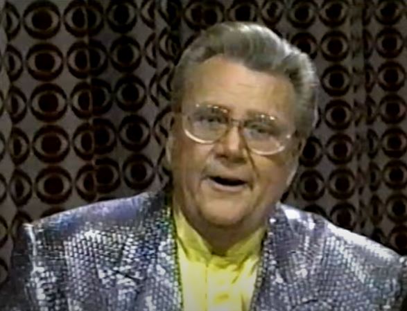 Rod is wearing a silver sequined jacket & yellow collarless silk shirt