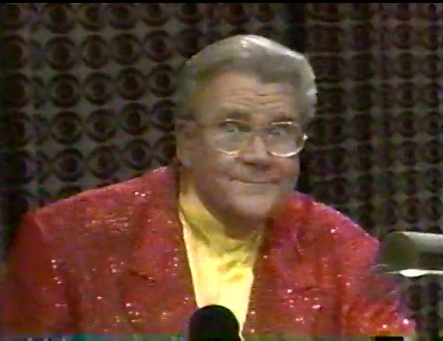 Rod is wearing a red sequined jacket & yellow collarless silk shirt