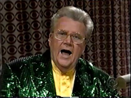 Rod is wearing a green sequined jacket & yellow collarless silk shirt