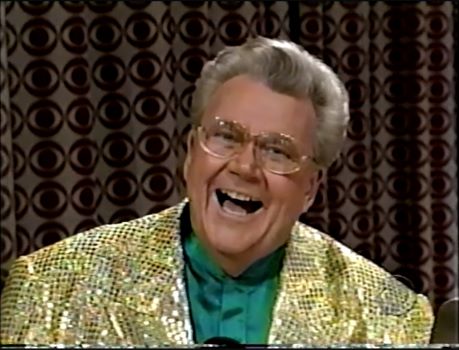 Rod is wearing a gold sequined jacket & green collarless silk shirt