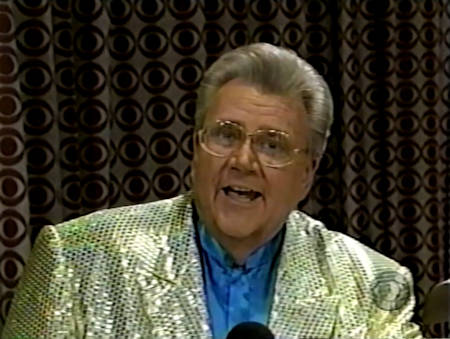 Rod is wearing a gold sequined jacket & blue collarless silk shirt