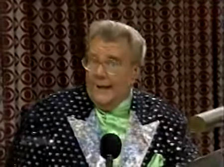 Rod is wearing a black jacket with silver polka dots and silver lapels & a lime-green collarless silk shirt with matching pocket square