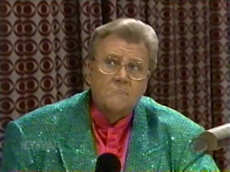 Rod is wearing a green sequined jacket & red collarless silk shirt