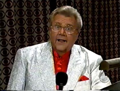 Rod is wearing a white-sequined jacket, red collarless silk shirt & matching pocket square